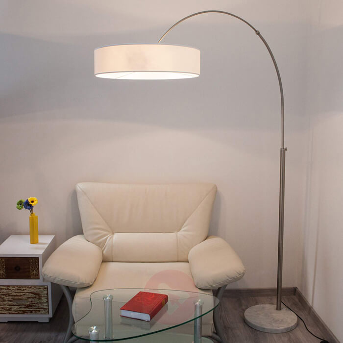 Photo of arc lamp with circular lampshade and circular cement floor lamp